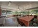 Bright dining area with tile flooring, ceiling fans, and large windows that offer views of the outdoor surroundings at 2620 Doyle Rd, Deltona, FL 32738