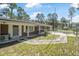 Exterior view of charming single-story home and gated backyard with manicured lawn at 2620 Doyle Rd, Deltona, FL 32738