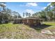 Rear exterior view of home with fenced yard and view of the lake at 2620 Doyle Rd, Deltona, FL 32738