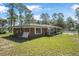 Exterior shot of charming single-story home with view of fenced in lawn at 2620 Doyle Rd, Deltona, FL 32738