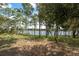 Scenic view of a serene lake framed by mature trees, offering a tranquil and picturesque setting at 2620 Doyle Rd, Deltona, FL 32738
