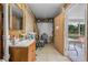 Functional laundry room featuring tile flooring, a sink, a storage shelf, and exterior access at 2620 Doyle Rd, Deltona, FL 32738
