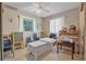 Comfortable living area featuring tables, a rolling cart and blue chairs at 2620 Doyle Rd, Deltona, FL 32738