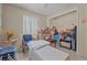 Comfortable living area featuring tables, a rolling cart and blue chairs at 2620 Doyle Rd, Deltona, FL 32738