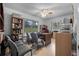 Inviting home office space featuring a ceiling fan, desk, shelving, and large windows overlooking the yard at 2620 Doyle Rd, Deltona, FL 32738