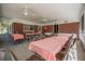 Enclosed porch with tile flooring, ceiling fans, and brick accent wall, perfect for gatherings at 2620 Doyle Rd, Deltona, FL 32738
