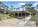 View of a screened-in porch with seating and an adjacent fenced yard at 2620 Doyle Rd, Deltona, FL 32738