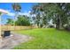 Spacious backyard with lush green grass and a new fence at 2633 Yale Rd, South Daytona, FL 32119