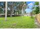 Spacious backyard with lush green grass and mature trees at 2633 Yale Rd, South Daytona, FL 32119