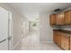 Kitchen and living area featuring tile flooring, wood cabinets and white appliances at 2633 Yale Rd, South Daytona, FL 32119
