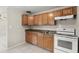 The kitchen includes ample wood cabinets, double sinks, and a white stove at 2633 Yale Rd, South Daytona, FL 32119