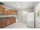 Traditional kitchen featuring wood cabinets, white appliances, and tile flooring at 2633 Yale Rd, South Daytona, FL 32119