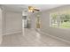 This living area features tile flooring, a ceiling fan, and neutral colors at 2633 Yale Rd, South Daytona, FL 32119
