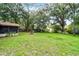 Expansive backyard featuring lush green grass and mature trees, perfect for outdoor activities at 270 Sandyhook Ln, Deland, FL 32724