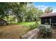 Spacious backyard with mature trees, patio, firepit, shed, and plenty of space for entertaining at 270 Sandyhook Ln, Deland, FL 32724