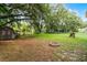 Large backyard featuring a fire pit and mature shade trees; a great space for outdoor activities at 270 Sandyhook Ln, Deland, FL 32724