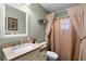 Bathroom with modern fixtures, granite countertop, decorative mirror, and bathtub with shower at 270 Sandyhook Ln, Deland, FL 32724