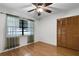 Cozy bedroom featuring hardwood floors, a ceiling fan, and a large double-door closet at 270 Sandyhook Ln, Deland, FL 32724