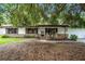 Charming single-story home featuring a brick facade and cozy front porch with rocking chairs and bench at 270 Sandyhook Ln, Deland, FL 32724