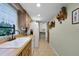 Efficient kitchen layout features white appliances, wood cabinets, and tiled floors at 270 Sandyhook Ln, Deland, FL 32724