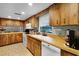 Traditional-style kitchen featuring wood cabinets, countertops, white appliances, and tile floors at 270 Sandyhook Ln, Deland, FL 32724
