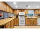 Functional kitchen equipped with white appliances, wood cabinets, and ample counter space at 270 Sandyhook Ln, Deland, FL 32724