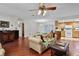 Bright open-concept living space flows into the kitchen featuring wood floors and neutral walls at 270 Sandyhook Ln, Deland, FL 32724