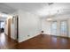 Bright living room with wood floors, a decorative hanging light, and glass doors to the outside at 270 Sandyhook Ln, Deland, FL 32724