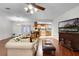 Well-lit living room featuring wood floors, neutral walls, and a clear view of the adjacent kitchen at 270 Sandyhook Ln, Deland, FL 32724