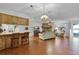 Spacious living room with wood floors, a brick fireplace, and open flow to kitchen area at 270 Sandyhook Ln, Deland, FL 32724