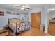 A bright main bedroom featuring a bed, hardwood floors, a closet and blue walls at 270 Sandyhook Ln, Deland, FL 32724