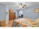 A bright main bedroom featuring a bed, hardwood floors, a closet and blue walls at 270 Sandyhook Ln, Deland, FL 32724