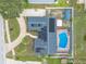 Overhead shot of a property with solar panels, a pool, a yard shed, and a concrete sidewalk at 2724 N Halifax Ave, Daytona Beach, FL 32118
