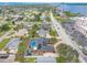An aerial shot shows a residential area with backyard pools and proximity to a tranquil bay with a long road nearby at 2724 N Halifax Ave, Daytona Beach, FL 32118