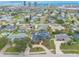 Picturesque aerial view of a neighborhood with swimming pools near urban towers and the ocean in the distance at 2724 N Halifax Ave, Daytona Beach, FL 32118
