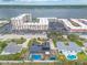 Bird's-eye view features homes with pools, a large condo complex, and a serene river backdrop with many cars at 2724 N Halifax Ave, Daytona Beach, FL 32118