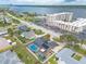 Aerial view of residences near a river showcases backyard pools and a large condominium complex with ample parking spaces at 2724 N Halifax Ave, Daytona Beach, FL 32118