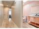 Hallway view of a delightful half-bath with stylish vanity, wood-look floors and modern fixtures at 2724 N Halifax Ave, Daytona Beach, FL 32118