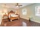 A charming bedroom with hardwood floors, a ceiling fan, and a classic wooden bed frame at 2724 N Halifax Ave, Daytona Beach, FL 32118