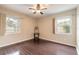 Well-lit bedroom with hardwood floors, two large windows, and contemporary ceiling fan at 2724 N Halifax Ave, Daytona Beach, FL 32118