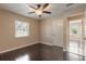 Bedroom featuring hardwood floors, bright window, ceiling fan and a white door at 2724 N Halifax Ave, Daytona Beach, FL 32118