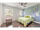 Bright bedroom featuring hardwood floors, modern ceiling fan, and a unique swan-themed accent wall at 2724 N Halifax Ave, Daytona Beach, FL 32118
