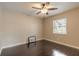 Cozy bedroom featuring hardwood floors, bright window, and a contemporary ceiling fan at 2724 N Halifax Ave, Daytona Beach, FL 32118