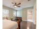 Bright bedroom with hardwood floors, ceiling fan, and view to the ensuite bathroom at 2724 N Halifax Ave, Daytona Beach, FL 32118