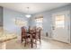 Light-filled dining area with blue walls, tile floors, table with seating for four, and access to back patio at 2724 N Halifax Ave, Daytona Beach, FL 32118