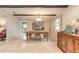 Dining room featuring ceiling beams, travertine tile flooring, and a modern chandelier at 2724 N Halifax Ave, Daytona Beach, FL 32118