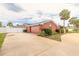 Spacious home exterior showing a large driveway, two car garage, and mature palm trees at 2724 N Halifax Ave, Daytona Beach, FL 32118
