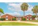 Charming brick home features lush landscaping, solar panels, and a gated entrance at 2724 N Halifax Ave, Daytona Beach, FL 32118