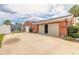 Exterior garage showcases a large sliding garage door with convenient side entry and a storage shed at 2724 N Halifax Ave, Daytona Beach, FL 32118