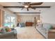 Spacious living room featuring ceiling beams, travertine tile floor, and sliding glass doors to the pool area at 2724 N Halifax Ave, Daytona Beach, FL 32118